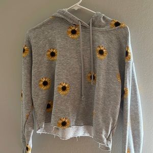 A comfy sunflower sweatshirt with a hood.